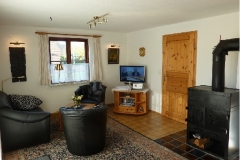 Sitzbereich mit 32‘‘LCD-SAT-TV, Blu Ray– und Radio/CD-Spieler, schwedischer Kaminofen, Terrassentür nach Süden, Fenster nach Süden und Westen